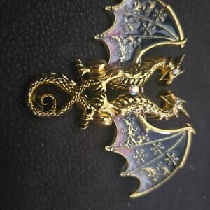 vintage-style gold-tone dragon brooch pin featuring enamel wings and rhinestone